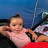 Emerson joined the competition — help win amazing prizes! toddler, child, stroller, pink_clothing, red_clothing, outdoor, tent, blue_background, relaxed, young_child, person, casual, summer, seat, small_person, clothing, portrait, resting, daylight, cute