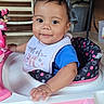 baby, bib, blue_shirt, child, curly_hair, cute, face, hand, happy, indoor, infant, minnie_mouse, person, pink, polka_dots, seat, smile, toy, walker, white