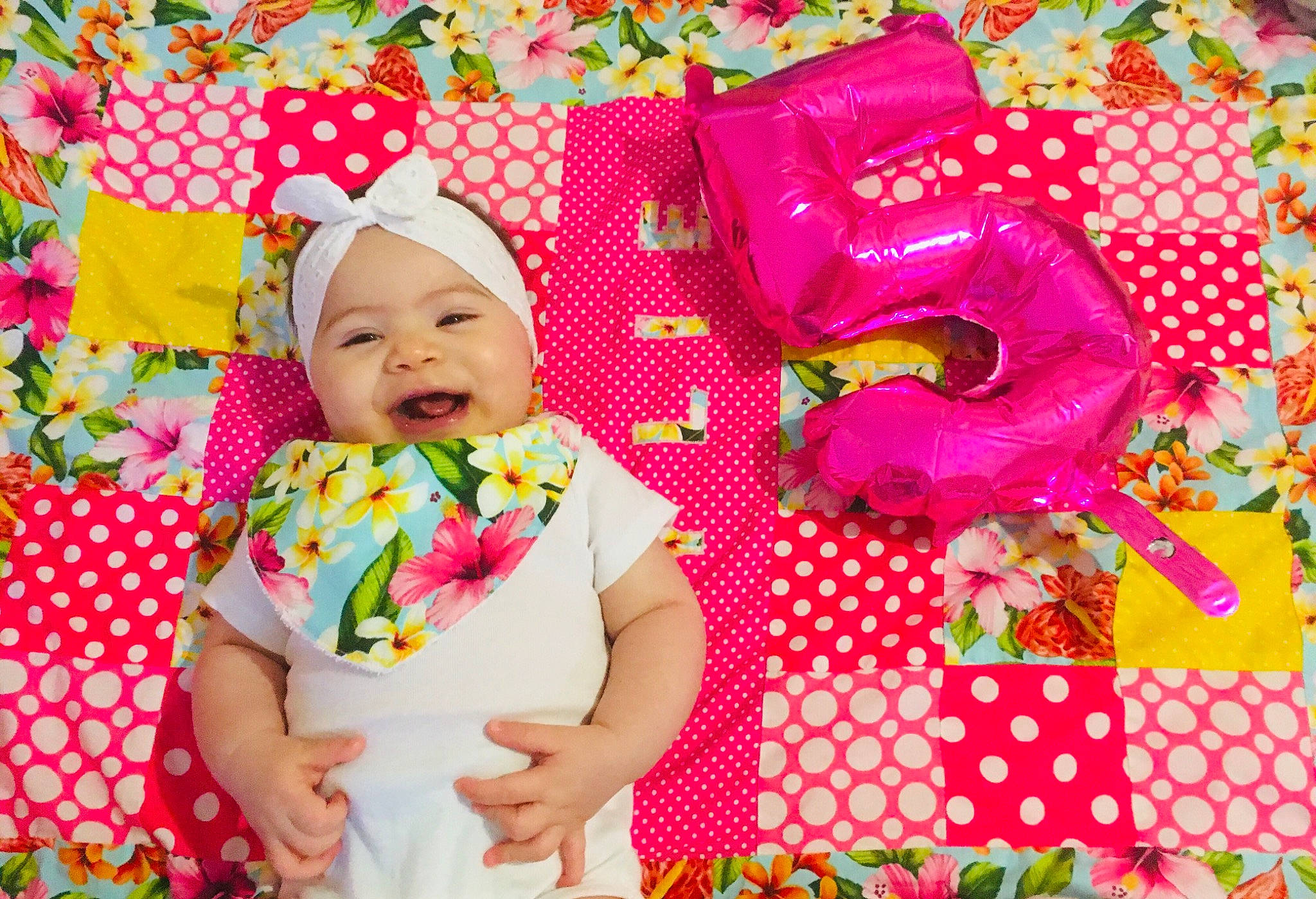 Kylie participe au concours pour gagner de l'argent avec cette photo : baby, baby_toddler_clothing, child, creative_arts, decoration, event, green, happy, headwear, linens, magenta, pattern, peach, people_in_nature, person, petal, pink, product, smile, textile