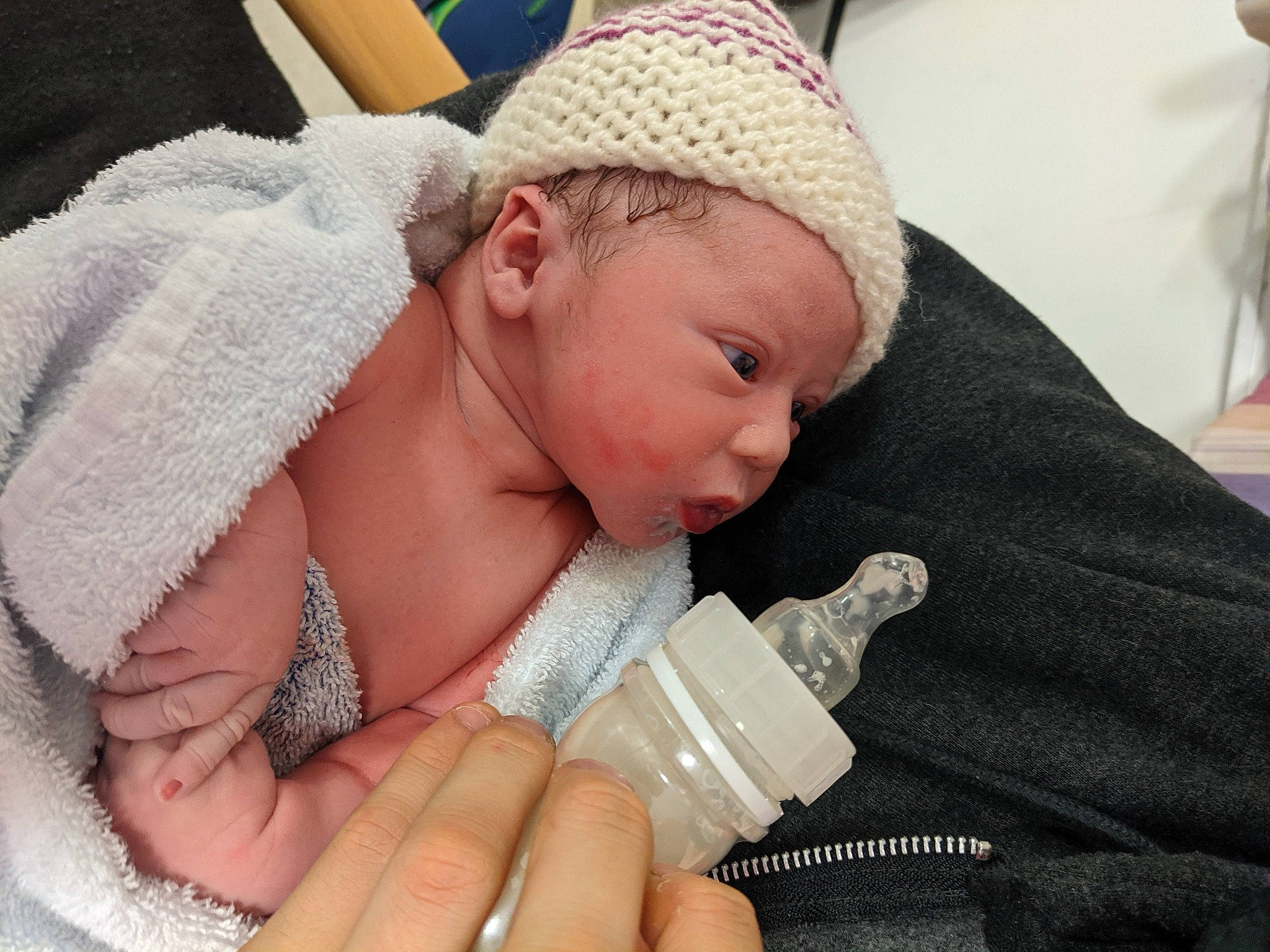 Kolby joined the competition — help win amazing prizes! baby, baby_bottle, baby_products, baby_toddler_clothing, bonnet, comfort, finger, hand, headgear, headwear, knit_cap, knitting, linens, milk, nail, person, plastic_bottle, skin, textile, thumb