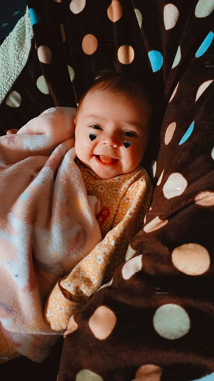 Chloie joined the competition — help win amazing prizes! baby, baby_products, baby_toddler_clothing, cheek, child, close_up, comfort, fashion_accessory, finger, flash_photography, happy, laugh, linens, pattern, person, portrait_photography, skin, smile, thumb, toddler