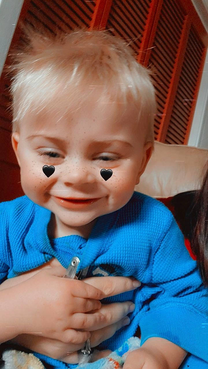 Zane is registered to the contest to win money with this photo: arm, azure, baby_toddler_clothing, cheek, chin, ear, eyebrow, eyelash, finger, gesture, hand, happy, human_body, iris, lip, mouth, nose, person, skin, thumb