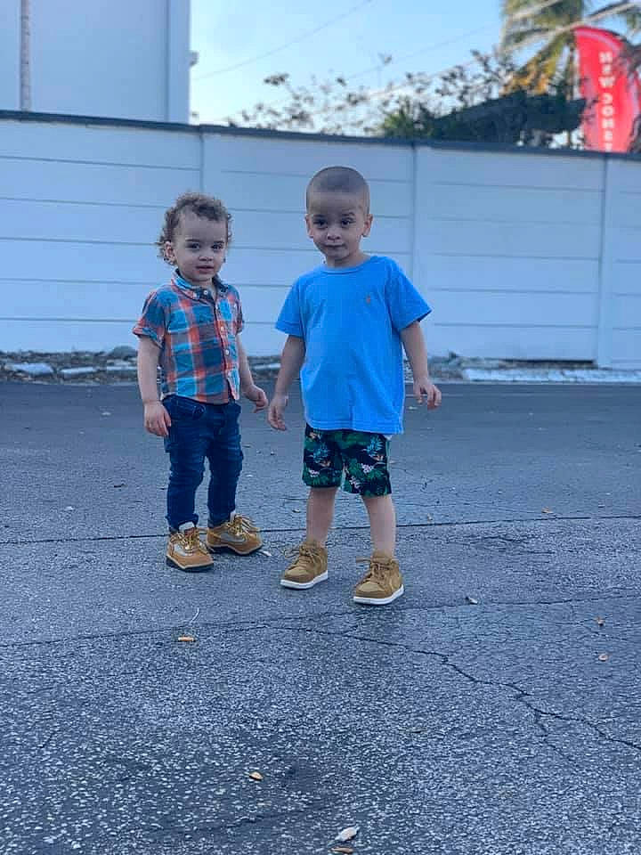 Ethan is registered to the contest to win money with this photo: asphalt, azure, child, city, concrete, denim, electric_blue, flag, fun, grass, leisure, person, recreation, road, road_surface, shorts, sidewalk, sky, t_shirt, toddler