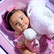 Paola joined the competition — help win amazing prizes! baby, bed, blanket, child, comfort, cuddling, cute, happy, headband, heart_pattern, indoor, infant, pink, plush, portrait, sleeping_area, smiling, soft_toy, teddy_bear, toddler