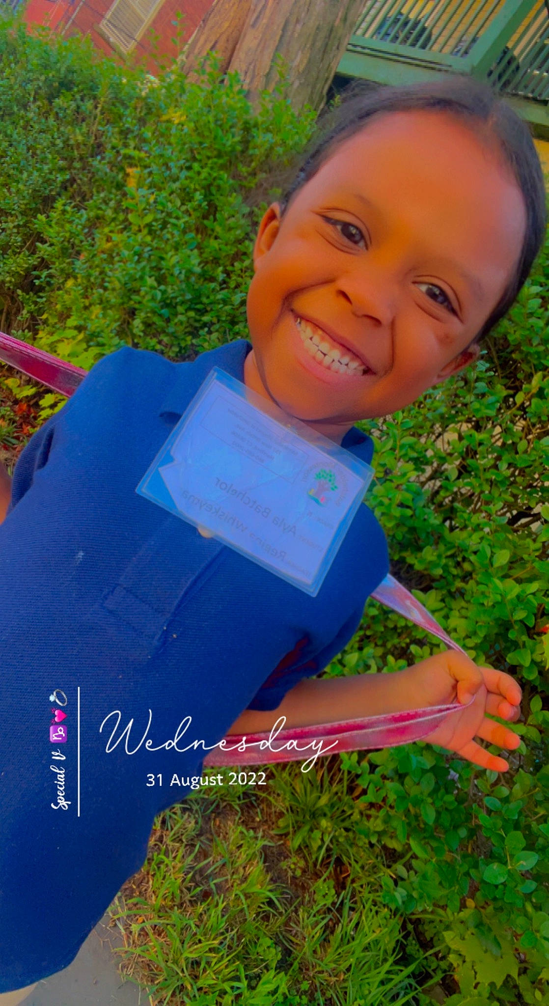 Ayla is registered to the contest to win money with this photo: child, electric_blue, eye, face, fun, garden, grass, happy, head, joy, leisure, people_in_nature, person, plant, play, recreation, sitting, smile, soil, t_shirt