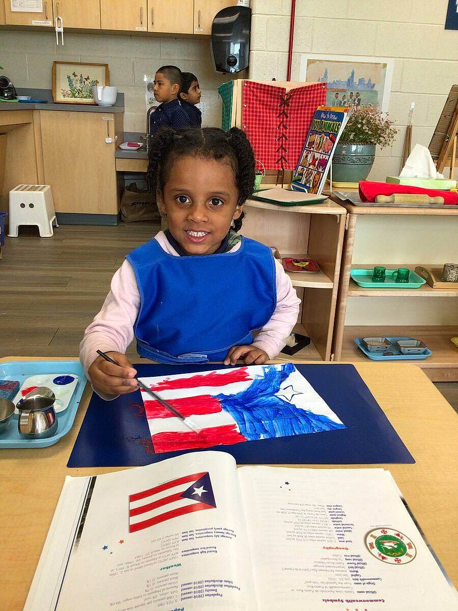 Alannah is registered to the contest to win money with this photo: academic_institution, carmine, chair, child, class, desk, education, engineering, fun, job, joy, learning, office_instrument, office_supplies, person, room, school, shelf, smile, t_shirt