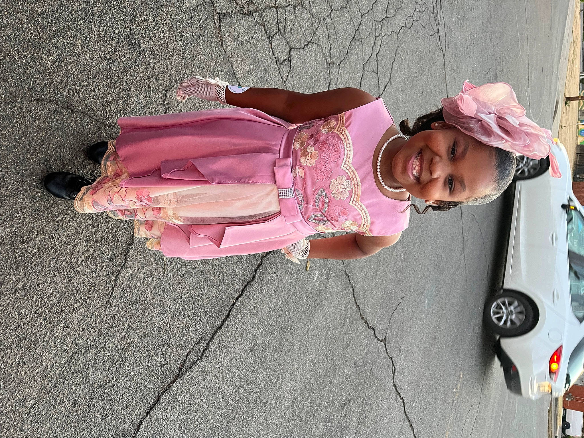 Beautiful is registered to the contest to win money with this photo: asphalt, baby, car, child, family_car, fun, hat, joy, leisure, magenta, person, pink, plant, smile, sun_hat, tire, toddler, tree, trunk, vehicle