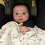 baby, infant, blanket, car_seat, child, face, head_support, wide_eyes, curious, cushion, clothing, soft_texture, indoor, portrait, cute, newborn, hand, pink, white, sleeping_bag