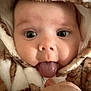 baby, face, tongue, hood, fuzzy, animal_print, cute, close_up, child, infant, eyes, expression, soft_texture, warm, snug, playful, portrait, clothing, person, funny_face