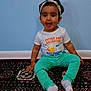 toddler, child, sitting, carpet, headband, shirt, pants, socks, wall, floor, indoor, smiling, happy, portrait, person, cute, clothing, baby, home, young