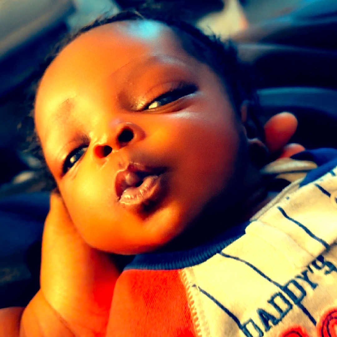 Julian is registered to the contest to win money with this photo: baby, bodypart, clothing, face, finger, hand, happy, head, mouth, newborn, person, photography, portrait, selfie, skin, sleeping, smile, t_shirt, tattoo, teeth