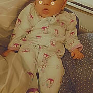 Anaya joined the competition — help win amazing prizes! baby, infant, pajamas, cute, face, daisy_stickers, child, indoors, window, cushion, polka_dots, slippers, hand, blanket, resting, soft_lighting, cozy, sleepwear, portrait, adorable