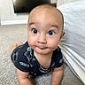 baby, infant, child, crawling, wide_eyed, surprised, smiling, face, portrait, indoor, bedroom, carpet, bed, television, ball, toy, clothing, black_outfit, home, photography