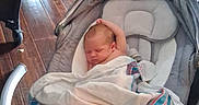 James joined the competition — help win amazing prizes! baby, newborn, sleeping, blanket, baby_rocker, wooden_floor, indoor, infant, resting, cozy, child, toddler, home, comfort, quiet, peaceful, person, nursery, fabric, soft
