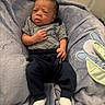 baby, infant, blanket, clothing, striped_shirt, blue_pants, white_socks, soft_texture, plush, embroidery, mouse_design, lying_down, curious_expression, indoors, closeup, newborn, baby_bedding, child, cute, portrait