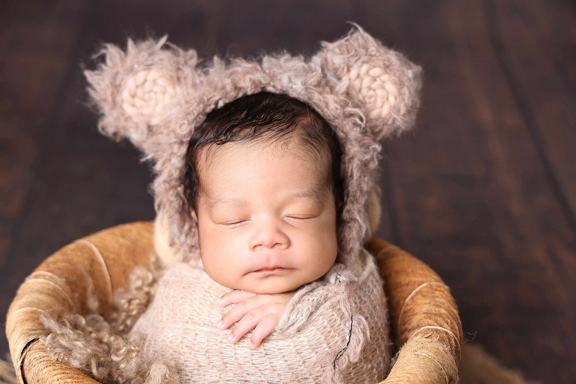 Jahzeiah is registered to the contest to win money with this photo: baby, sleeping, swaddled, knitted_wrap, bear_ears, hat, basket, cozy, peaceful, newborn, infant, cute, portrait, soft_texture, warm_colors, hand, face, closed_eyes, fuzzy, wooden_background