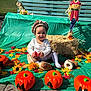 baby, child, pumpkin, fall, autumn, leaves, scarecrow, hay_bale, green_backdrop, outdoor, sunny, smiling, sitting, toddler, costume, decorations, festive, seasonal, playful, cute