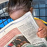 Yamanie joined the competition — help win amazing prizes! child, newspaper, yellow_bow, curly_hair, hand, reading, chair, metal, background, curiosity, face_hidden, indoor, casual, person, clothing, fingers, hair, bright_color, young, sitting