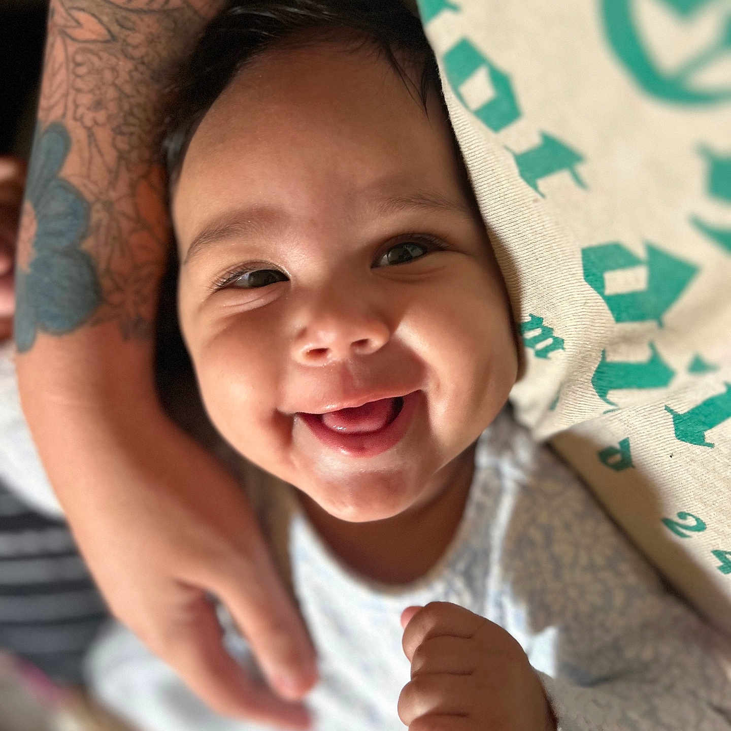Alizah joined the competition — help win amazing prizes! baby, babylaughing, bodypart, clothing, face, finger, hand, happy, head, laughing, mouth, newborn, person, photography, portrait, skin, smile, t_shirt, tattoo, teeth