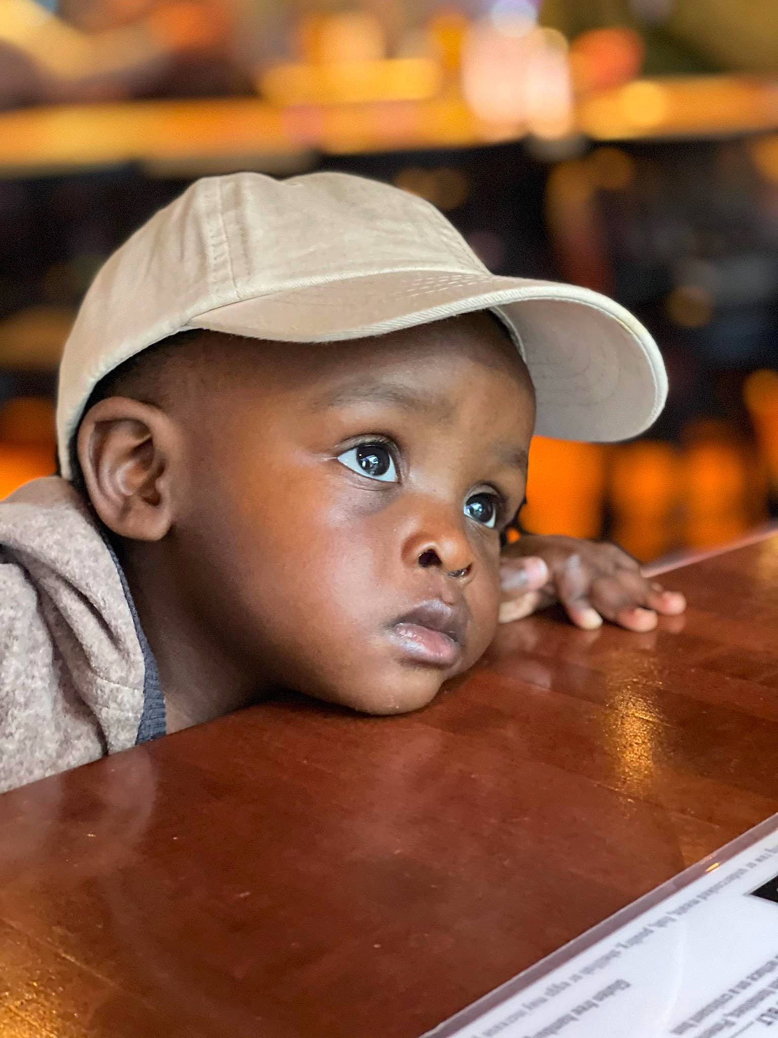 Alonzo joined the competition — help win amazing prizes! cap, cheek, child, chin, fashion_accessory, fun, happy, hat, headgear, laugh, lip, mouth, nose, person, portrait_photography, sitting, table, toddler, vacation, varnish