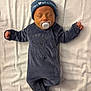 newborn, baby, sleeping, pacifier, onesie, hat, blue_clothing, blanket, infant, cute, peaceful, indoor, portrait, soft_texture, child, resting, closed_eyes, small_hands, adorable, sleep