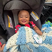 Jayceon is registered to the contest to win money with this photo: baby, infant, child, smiling, car_seat, car_interior, blanket, crocheted_blanket, pacifier, harness, portrait, happy, sitting, vehicle, travel, closeup, face, safe, colorful_clothing, indoor