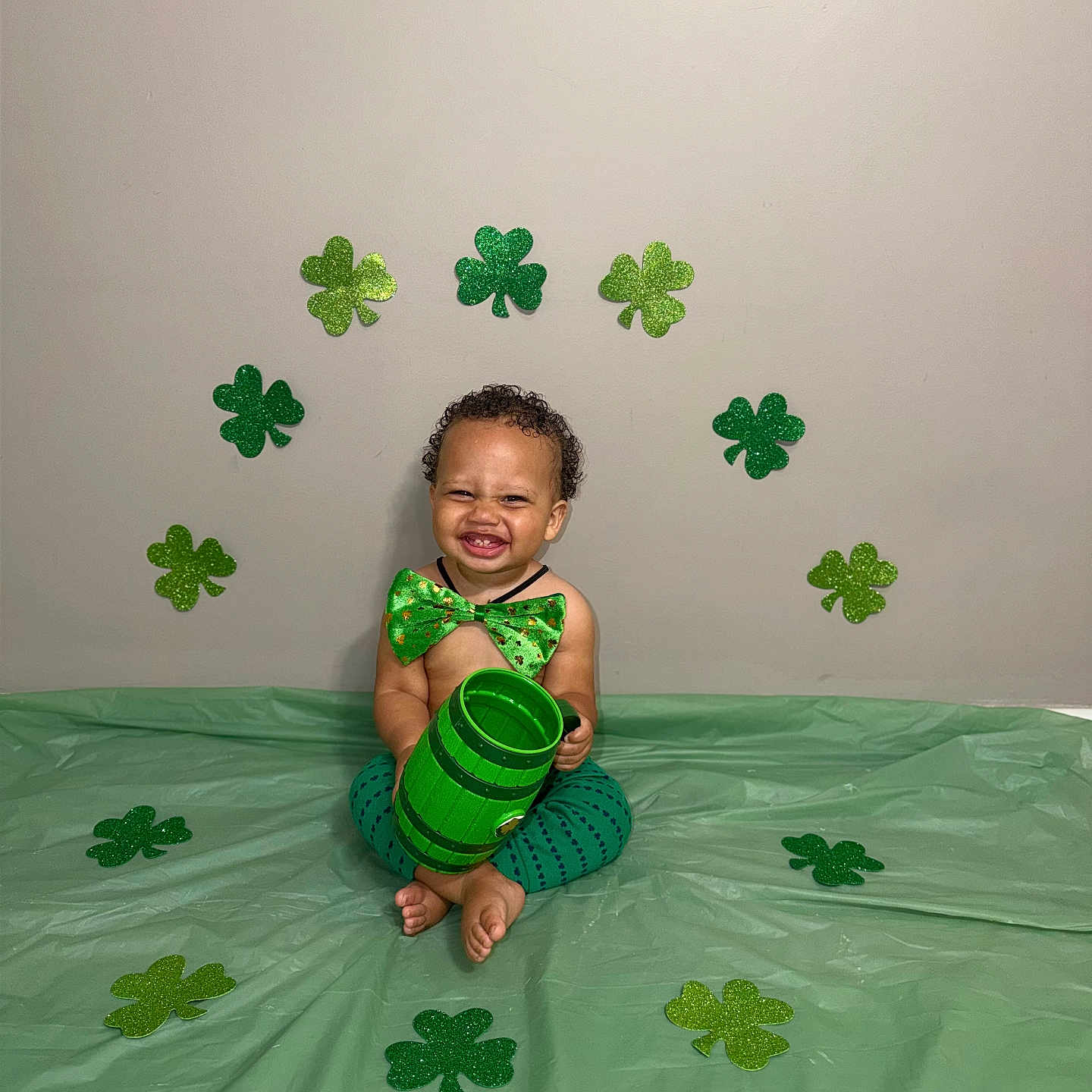 Makenai joined the competition — help win amazing prizes! toddler, child, smiling, green_bowtie, green_pants, bare_chest, shamrocks, st_patricks_day, green_cup, floor_covering, decorations, celebration, happy, indoor, curly_hair, cute, sitting, tooth_grin, festive, party