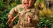 Makenai joined the competition — help win amazing prizes! baby, binoculars_case, child, curly_hair, elephant, explorer, giraffe_toy, greenery, happy, jungle, lion, outdoor, playful, portrait, safari_outfit, sitting, smiling, toddler, tropical_forest, vegetation