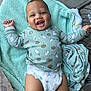 Makenai is registered to the contest to win money with this photo: baby, baby_garment, blanket, child, clothing, comfort, cookies, cute, diaper, face, hand, happy, head, indoor, infant, leg, lying_down, milk_pattern, smiling, soft_texture