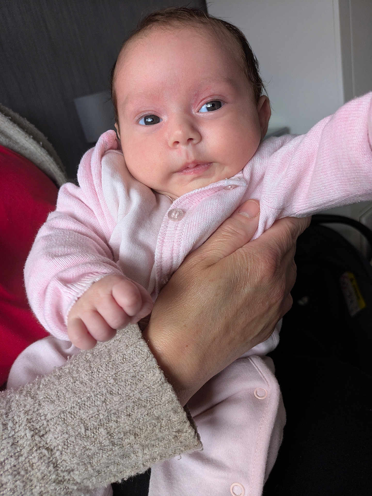 Timisha is registered to the contest to win money with this photo: baby, infant, child, hand, pink_clothing, person, portrait, indoor, soft_light, cute, newborn, holding, sleeve, face, skin, fingertips, warm, cozy, human, expression