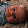 Kohen is registered to the contest to win money with this photo: baby, smiling, face, blanket, texture, blue_clothing, lying_down, closeup, infant, child, soft_light, cozy, indoors, skin, head, eyes, happy, portrait, cute, relaxed