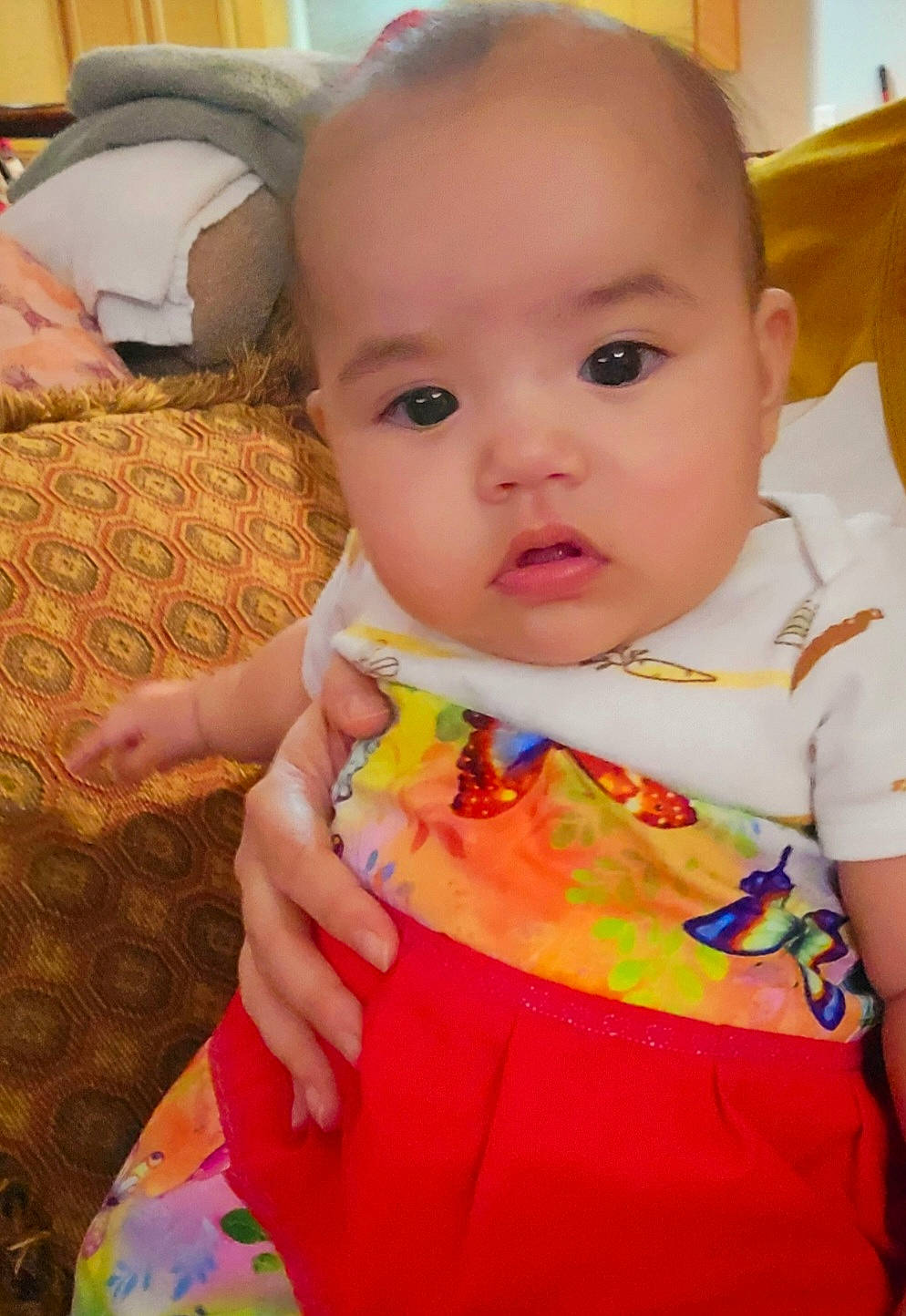 Viola is registered to the contest to win money with this photo: baby, baby_toddler_clothing, cheek, child, chin, face, finger, fun, happy, head, iris, magenta, neck, nose, pattern, person, pink, sitting, skin, sleeve