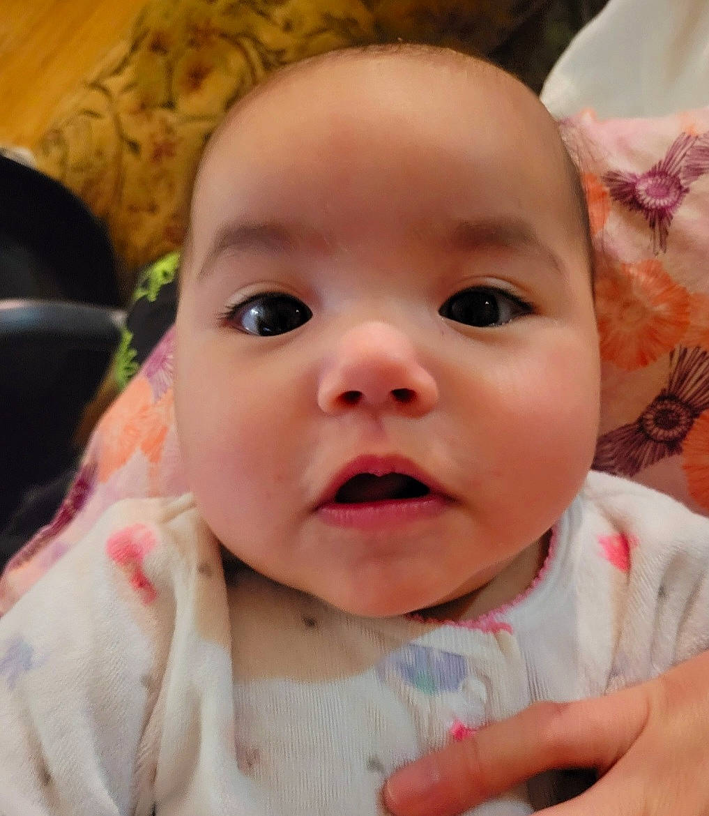 Viola is registered to the contest to win money with this photo: baby, baby_toddler_clothing, cheek, chin, ear, eye, eyebrow, eyelash, face, finger, gesture, hand, happy, head, iris, lip, mouth, nose, person, pink