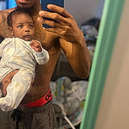Armoni joined the competition — help win amazing prizes! baby, casual, child, clothing, curious, family, holding, home, indoor, living_room, man, mirror, pajamas, person, phone, portrait, reflection, selfie, shirtless, technology