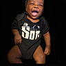 Armoni joined the competition — help win amazing prizes! baby, black_clothing, child, closeup, cute, dark_background, face, hands, happy, head, infant, joy, laughing, onesie, person, portrait, sitting, skin, smiling, studio_lighting