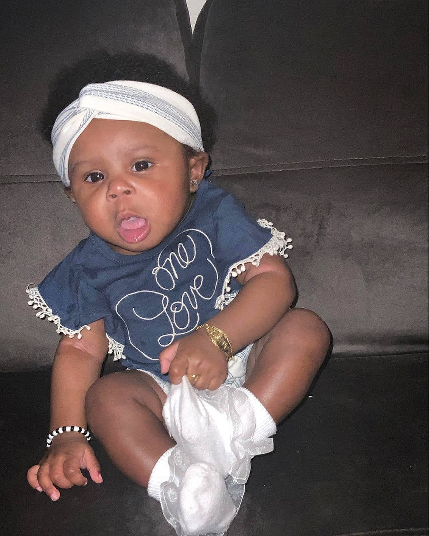 Kaliah is registered to the contest to win money with this photo: baby, baby_toddler_clothing, cap, child, chin, costume_hat, electric_blue, fashion_accessory, flash_photography, fun, happy, hat, headgear, headwear, human_leg, knee, person, skin, sleeve, t_shirt