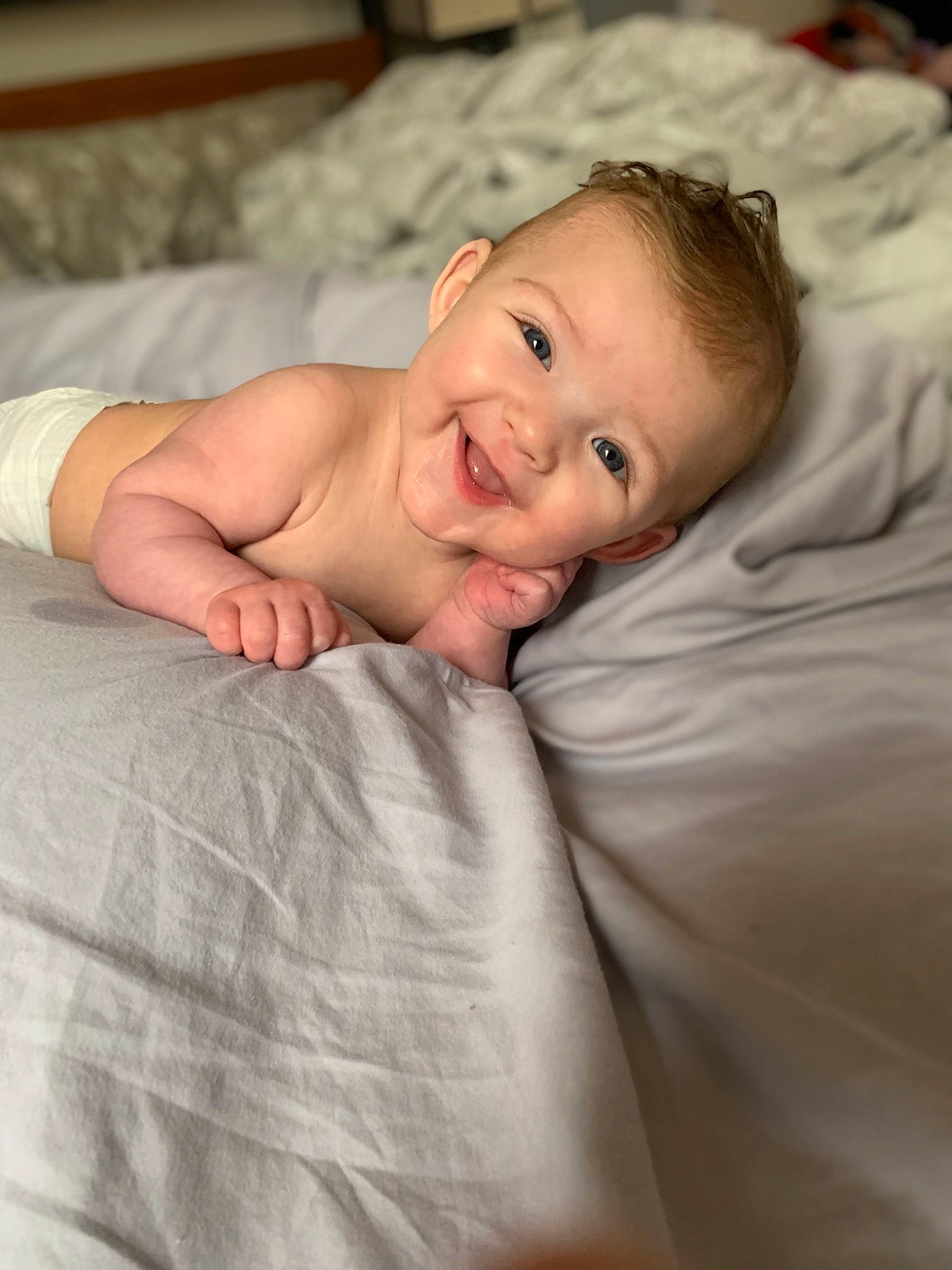 Ada is registered to the contest to win money with this photo: arm, baby, baby_toddler_clothing, cheek, child, comfort, event, eye, flash_photography, flooring, happy, iris, joy, linens, lip, nose, person, portrait_photography, sitting, skin