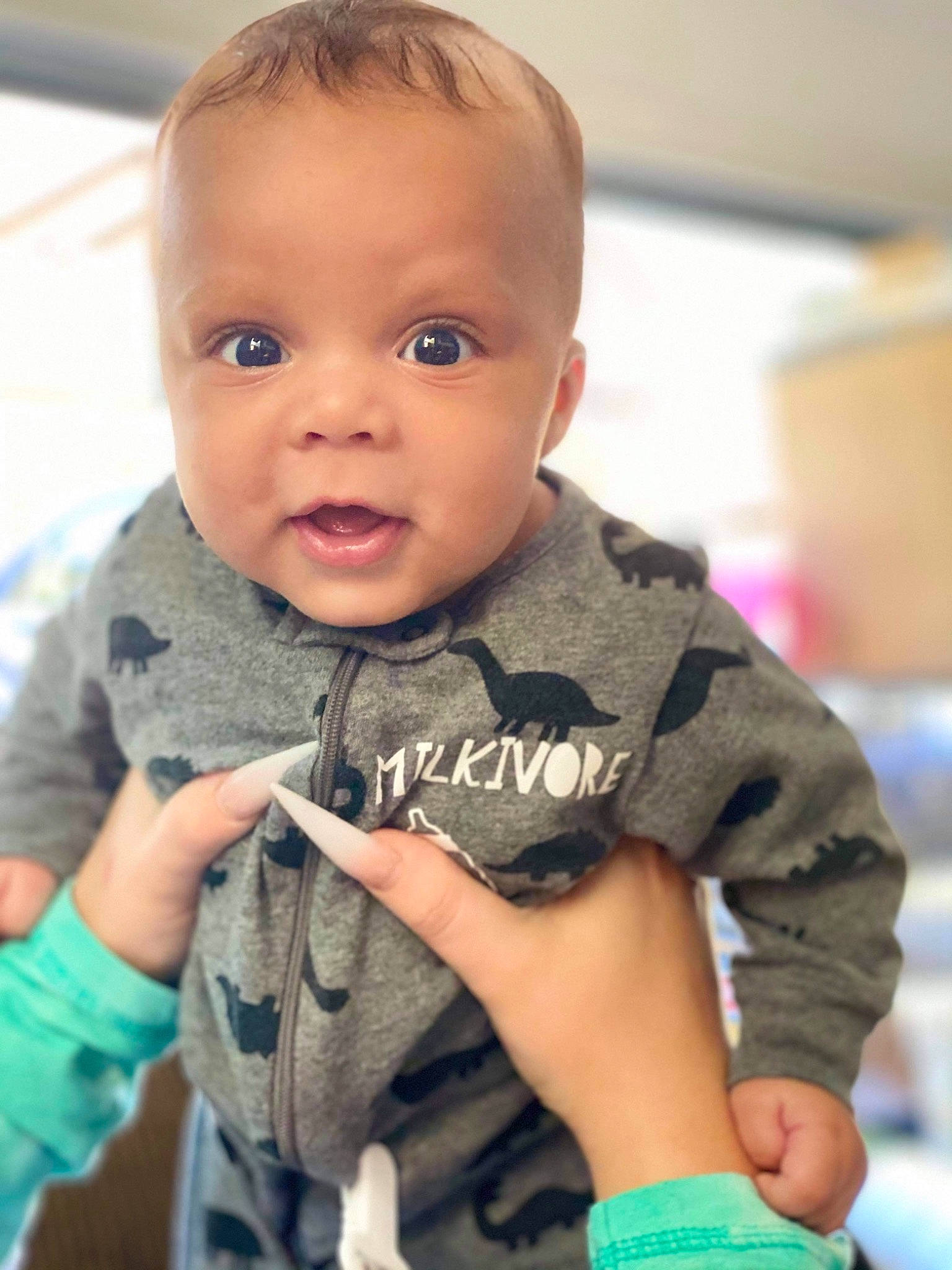 Jaeden is registered to the contest to win money with this photo: baby, baby_toddler_clothing, cheek, child, chin, eye, finger, gesture, hand, happy, human_body, iris, nail, nose, person, skin, sleeve, smile, t_shirt, thumb