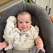 Hailey participe au concours pour gagner de l'argent avec cette photo : baby, infant, smile, blanket, pacifier, seat, cushion, clothing, hand, indoor, person, cute, child, soft_toy, comfort, head, face, expression, relaxation, home