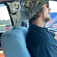 Seamus joined the competition — help win amazing prizes! animal, beard, bucket_hat, car, car_seat, cat, collar, curious, daylight, driving, hat, indoor, kitten, man, person, pet, seat_cover, sunglasses, vehicle_interior, window