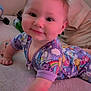 baby, child, pajamas, crawling, carpet, drool, smiling, face, skin, person, background, indoor, clothing, hand, arm, head, eyes, happy, home, colorful