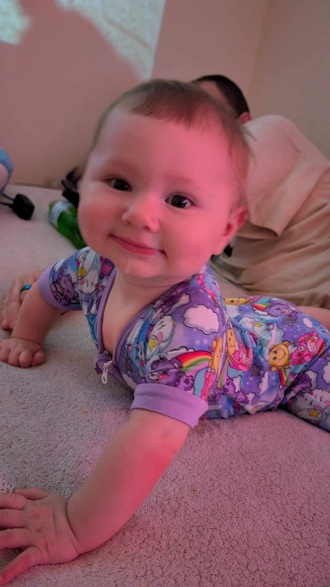 Isabella is registered to the contest to win money with this photo: baby, child, pajamas, crawling, carpet, drool, smiling, face, skin, person, background, indoor, clothing, hand, arm, head, eyes, happy, home, colorful