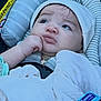 Malachi is registered to the contest to win money with this photo: baby, infant, car_seat, hat, blanket, clothing, child, face, headwear, seatbelt, striped, cute, indoors, young_child, person, portrait, sitting, hand, expression, warm