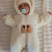 Gabriel participe au concours pour gagner de l'argent avec cette photo : baby, sleeping, pacifier, onesie, fluffy, bear_costume, hood, blanket, soft_texture, infant, cute, cozy, child, laying_down, closed_eyes, warm_clothing, indoors, comfortable, adorable, resting
