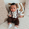 baby, infant, child, cute, sitting, couch, pillow, clothing, socks, indoors, portrait, face, expression, texture, comfort, home, soft, young, apparel, cozy