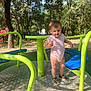 Jean a rejoint le concours — aidez-le/la à gagner de superbes lots ! blue, child, fun, grass, green, happy, merry_go_round, nature, onesie, outdoor, park, person, play, playground, sandals, shadows, summer, sunlight, toddler, trees