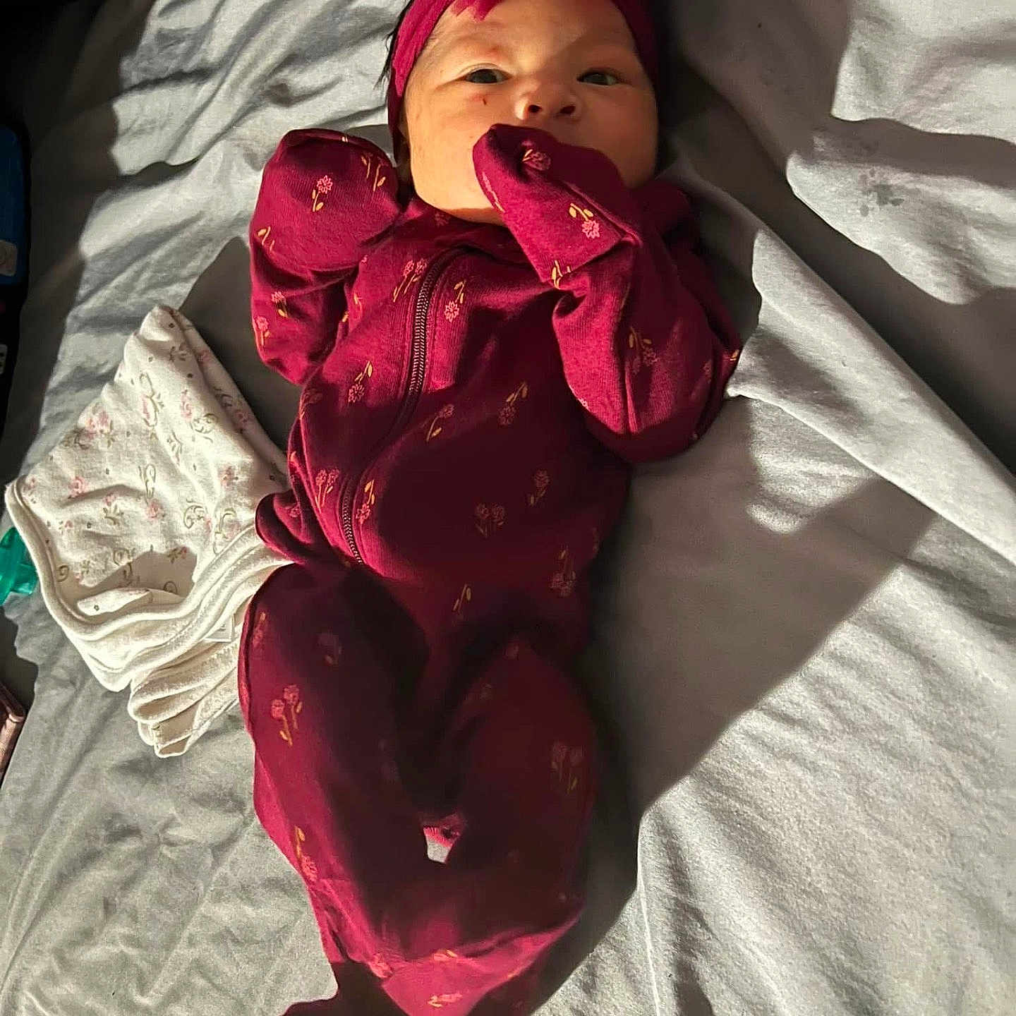 Naziyah joined the competition — help win amazing prizes! baby, babylaughing, bed, biting, blanket, clothing, coat, cushion, face, furniture, happy, head, hood, jacket, pajamas, person, photography, portrait, sleeve, yawning