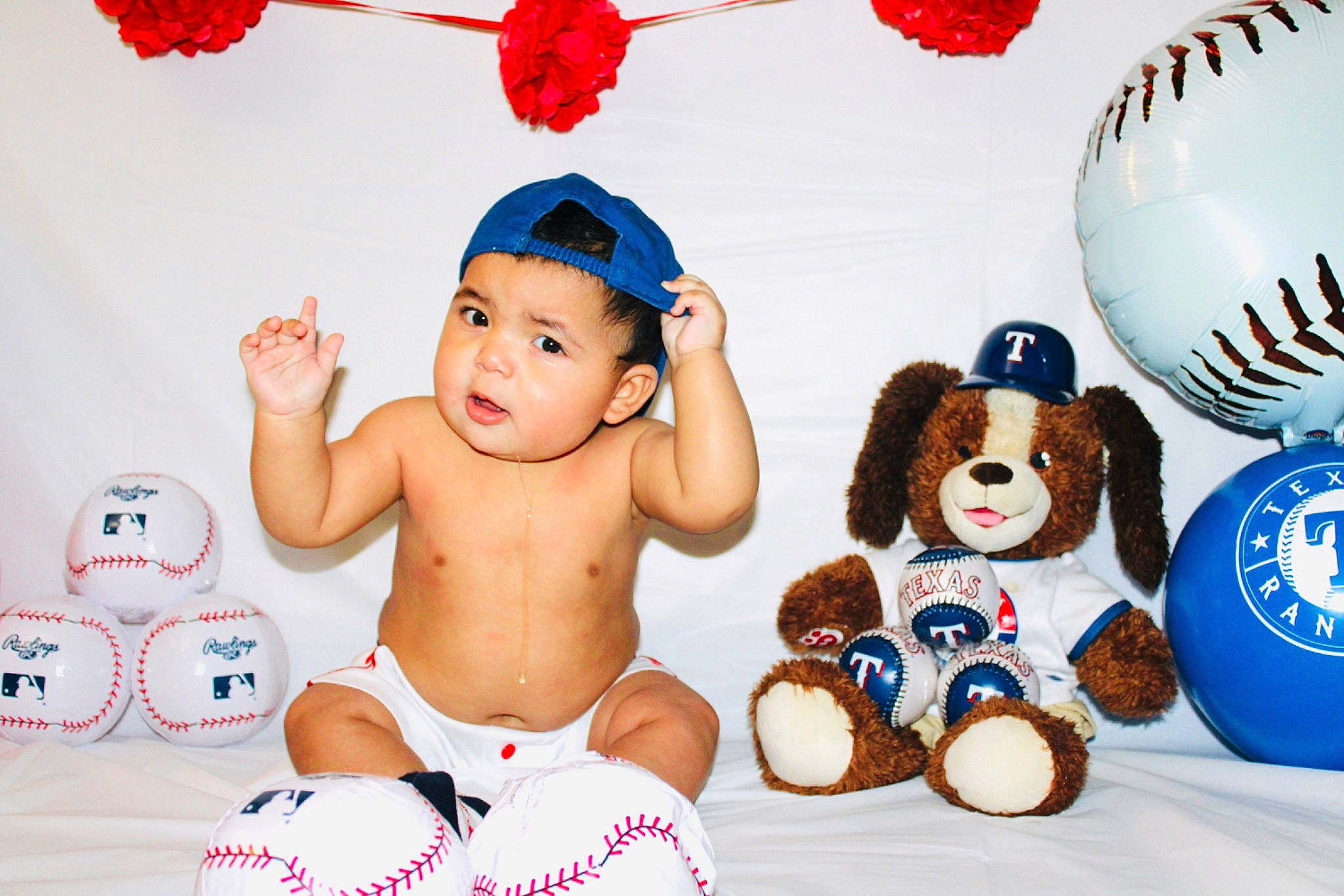 Ryan Eli is registered to the contest to win money with this photo: baby, baby_playing_with_toys, baby_toddler_clothing, blue, child, event, facial_expression, fashion_accessory, font, fun, happy, party_supply, people, person, product, red, stuffed_toy, teddy_bear, toddler, toy