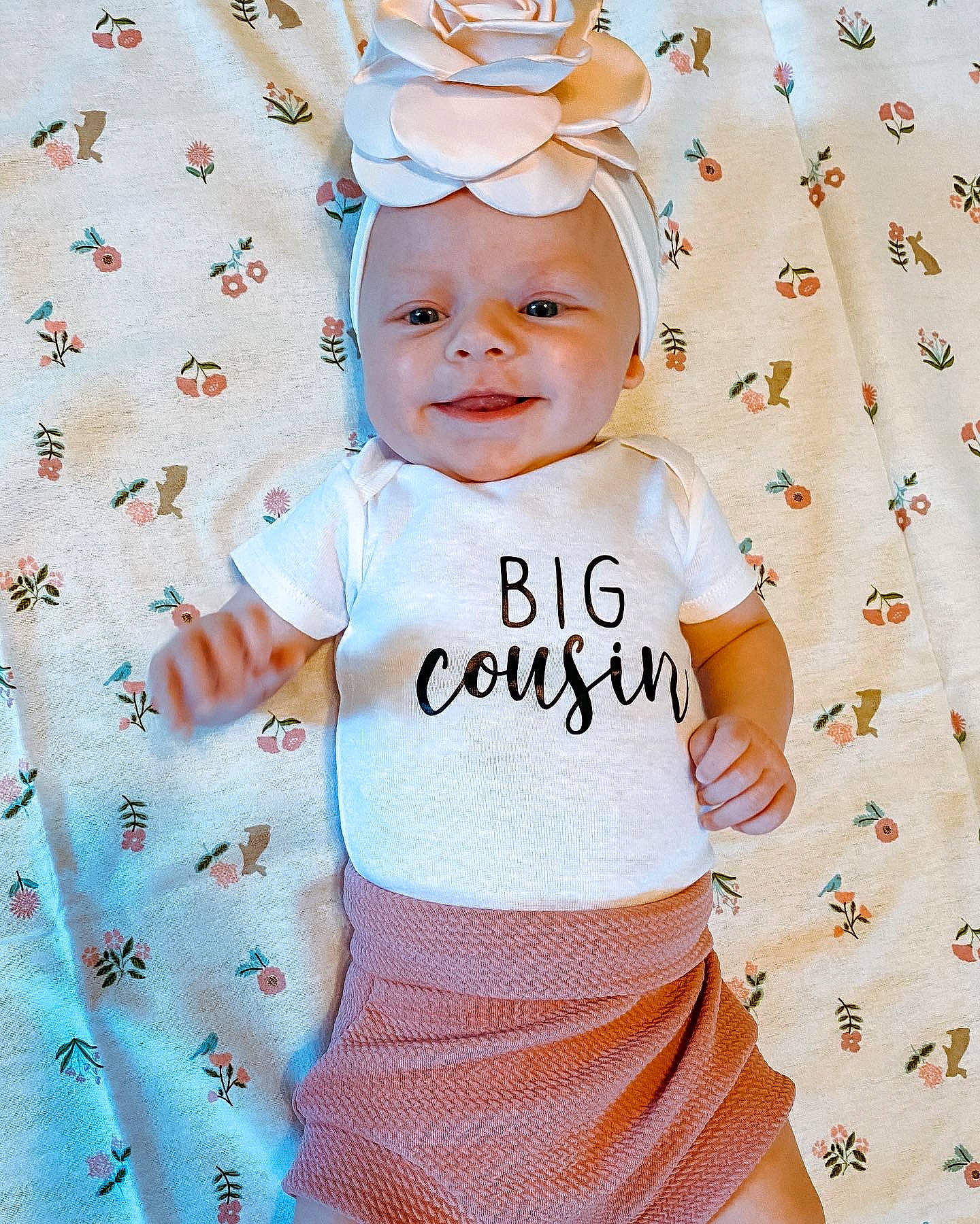 Lylah joined the competition — help win amazing prizes! baby, baby_toddler_clothing, cap, child, costume_hat, design, face, facial_expression, font, happy, headwear, one_piece_garment, pattern, person, pink, product, sleeve, smile, t_shirt, textile