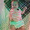 baby, child, smile, striped_clothing, blanket, pattern, cheerful, infant, lying_down, soft_toys, cozy, cute, happy, small_hands, small_feet, indoor, fabric, plaid, zigzag_pattern, casual
